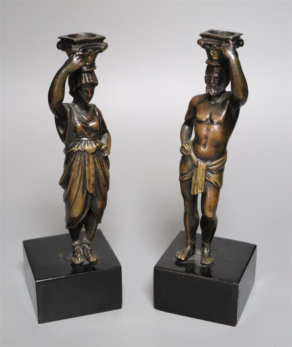 A pair of 19th century bronze figural candlesticks (once part of a clock), indistinctly stamped to reverse, overall height 23cm